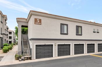 Building exterior with garages and stairs
